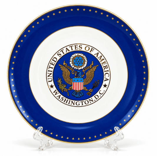 Blue and white decorative plate with U.S. seal center and gold star ring, on stand