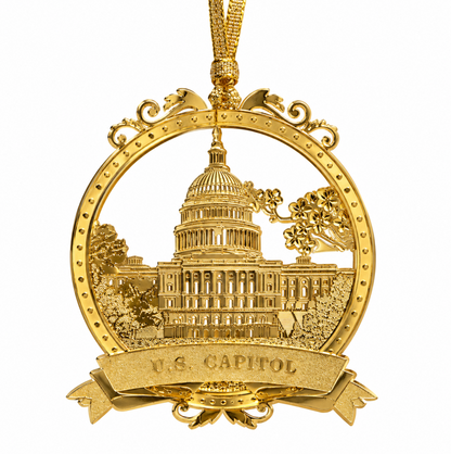 Gold-tone Capitol dome ornament in oval frame with scrollwork and 'U.S. CAPITOL' text.