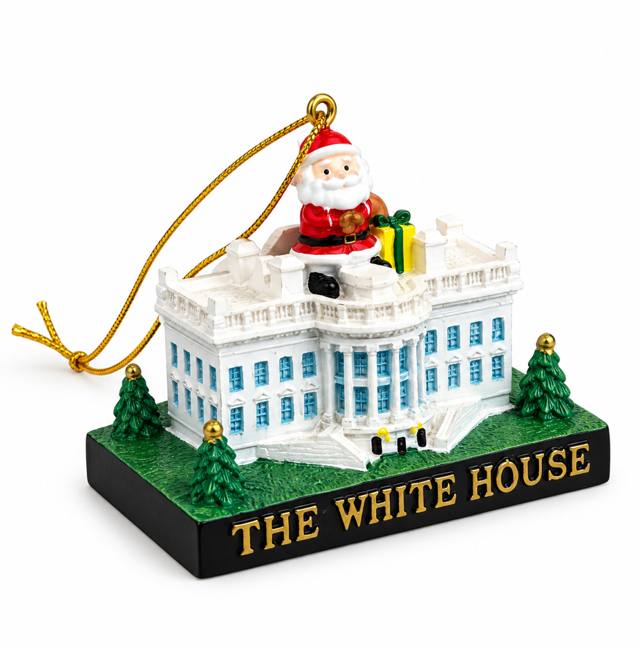 Ceramic house Christmas ornament with rooftop Santa, green trees, and gold hanging loop