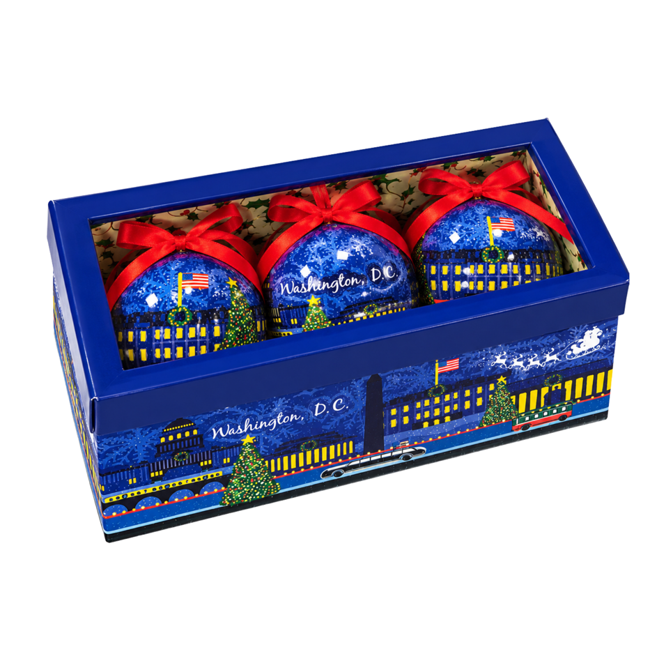 Boxed set of 3 blue Christmas ball ornaments with red bows and city skyline design