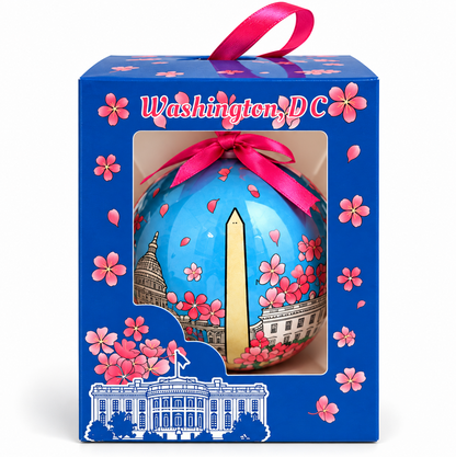 Boxed Christmas ornament with blue cherry blossom ball and pink ribbon bow, Washington DC
