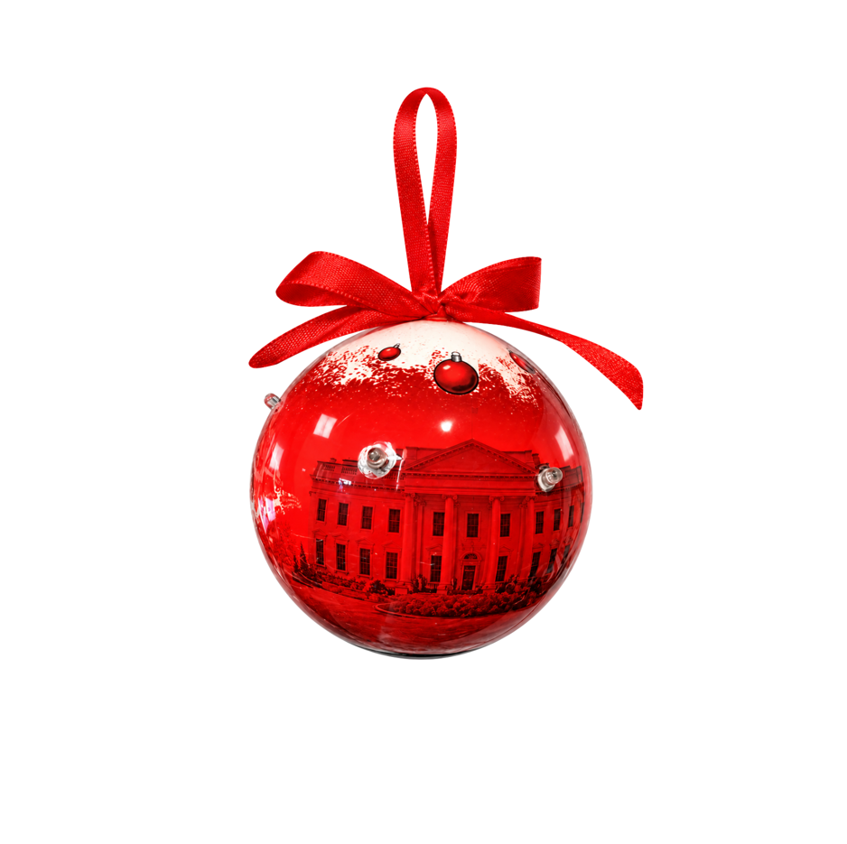 Red ball ornament with ribbon bow and building silhouette design